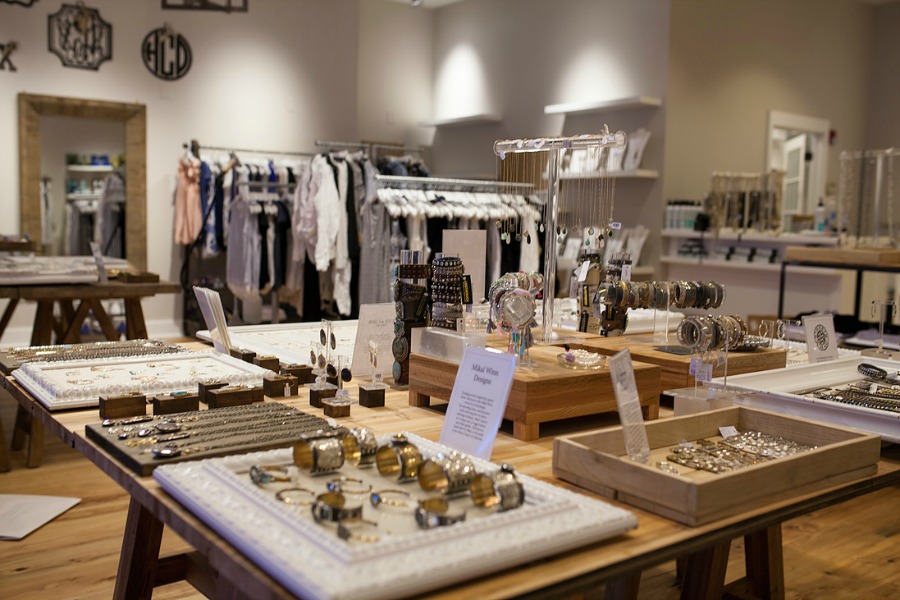 Alixandra Collections indoor store with jewelry and clothes on display Alixandra Collections indoor store with jewelry and clothes on display