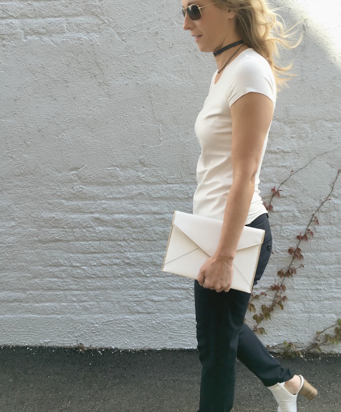 woman wearing white top, black jeans, and Choker Trend woman wearing white top, black jeans, and Choker Trend
