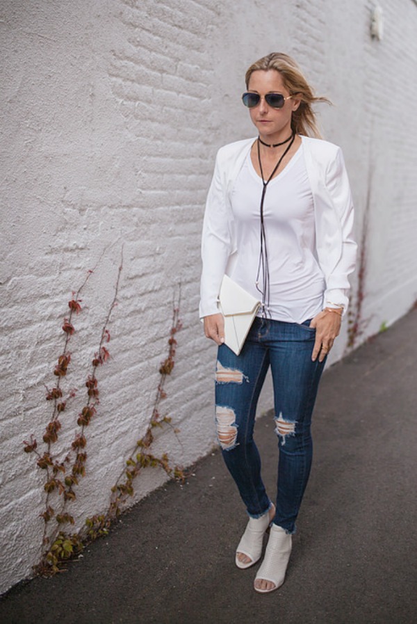 woman in white top and tattered jeans woman in white top and tattered jeans