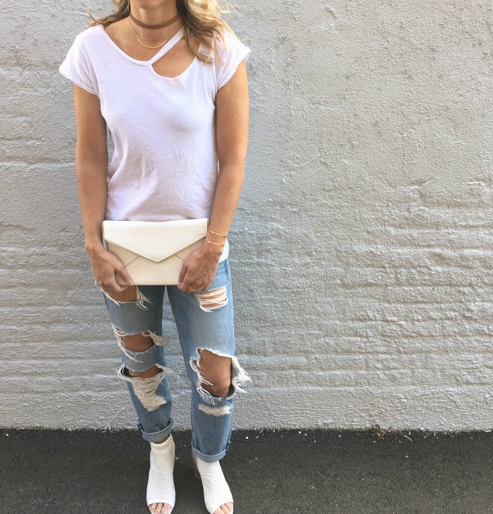 woman wearing white shirt and tattered jeans woman wearing white shirt and tattered jeans
