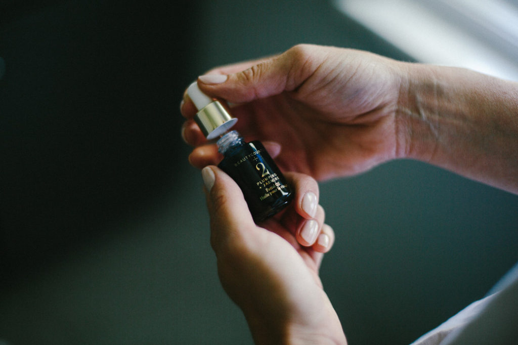 woman holding a beauty product woman's hands holding a Clean Beauty Brands