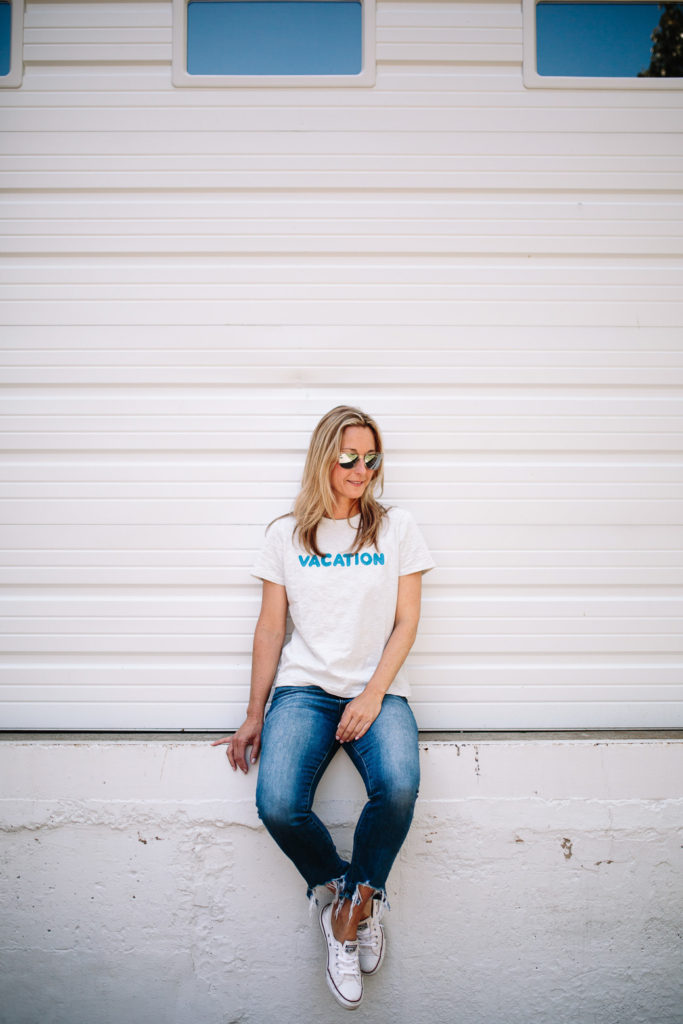 woman sitting woman spending Summer in Chicago and sitting on down wearing shirt and jeans