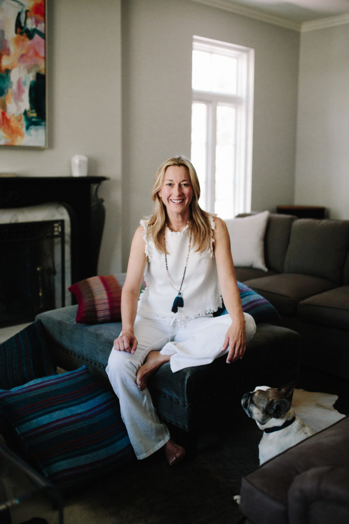 woman on a couch woman sitting on blue couch for Decor Trends
