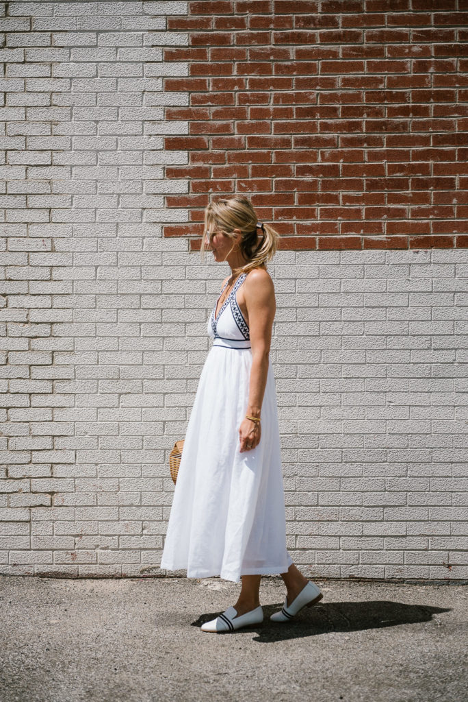 woman in white summer dresses with white flats woman walking and wearing a white summer dresses with white flats