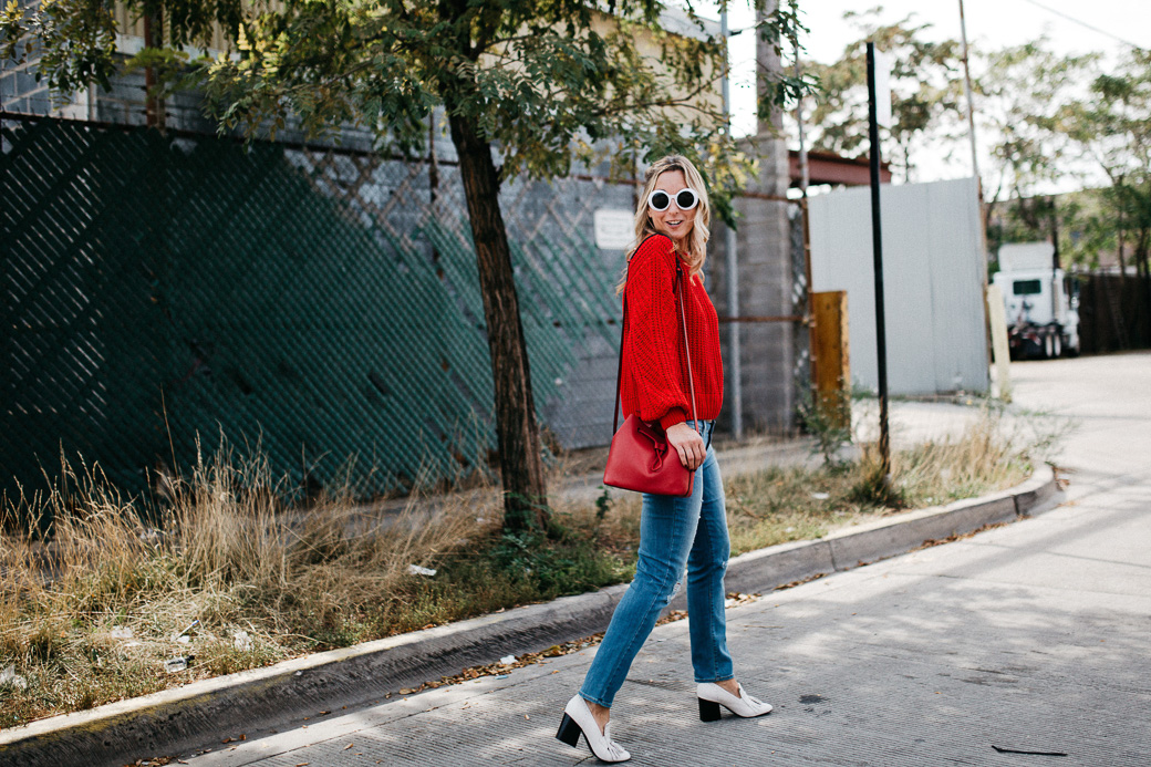 fall outfit with a warm sweater in red and blue jeans, 5 Sweaters Needed For Fall
