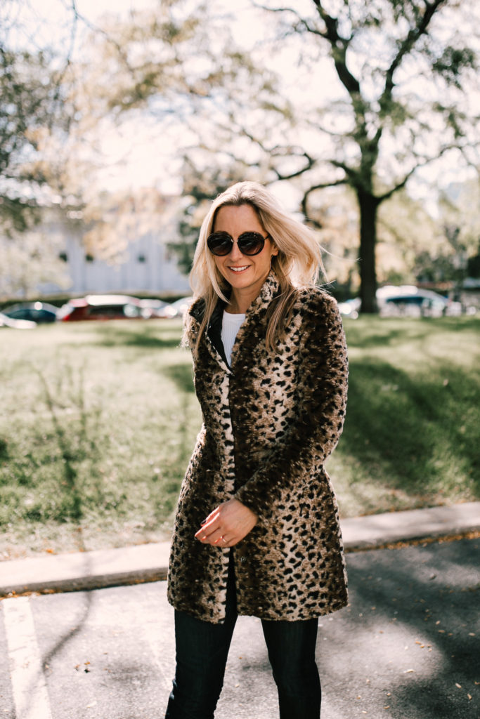 woman smiling and wearing a Leopard print jacket woman smiling and wearing a Leopard print jacket