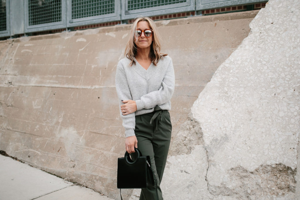 woman wearing sweater and paper-bag pant woman wearing paper-bag pant and tucked in sweater