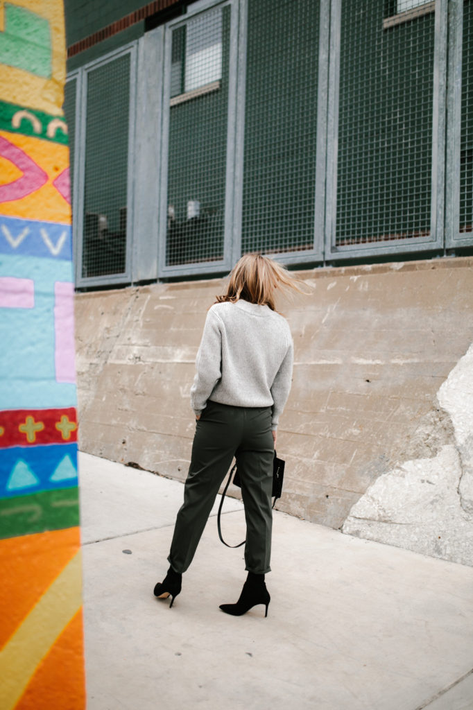 woman's back woman turning her back wearing sweatshirt and paper-bag pant