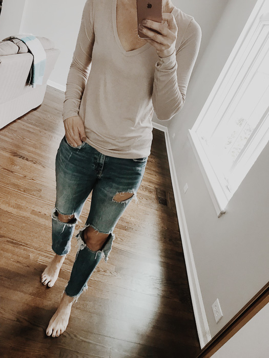 woman wearing A neutral basic long sleeve tee in blush tone is perfect for spring woman wearing A neutral basic long sleeve tee in blush tone is perfect for spring