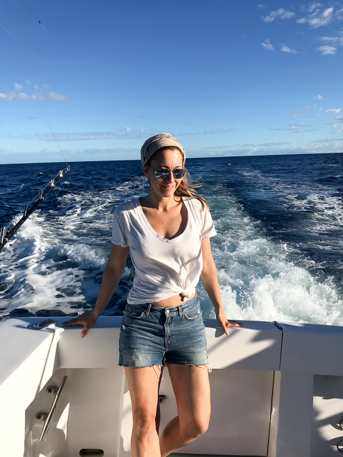 woman wearing White Tee, Denim Shorts, Ray-Bans, Bandana in Hair woman wearing White Tee, Denim Shorts, Ray-Bans, Bandana in Hair