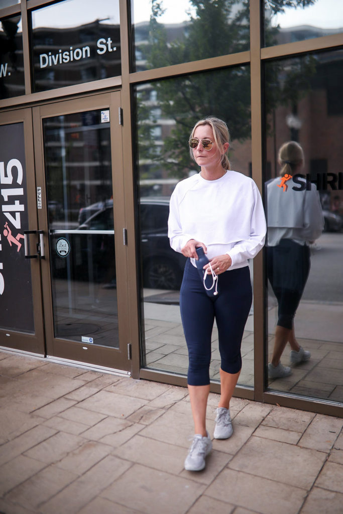 a female in shades and white athletic top